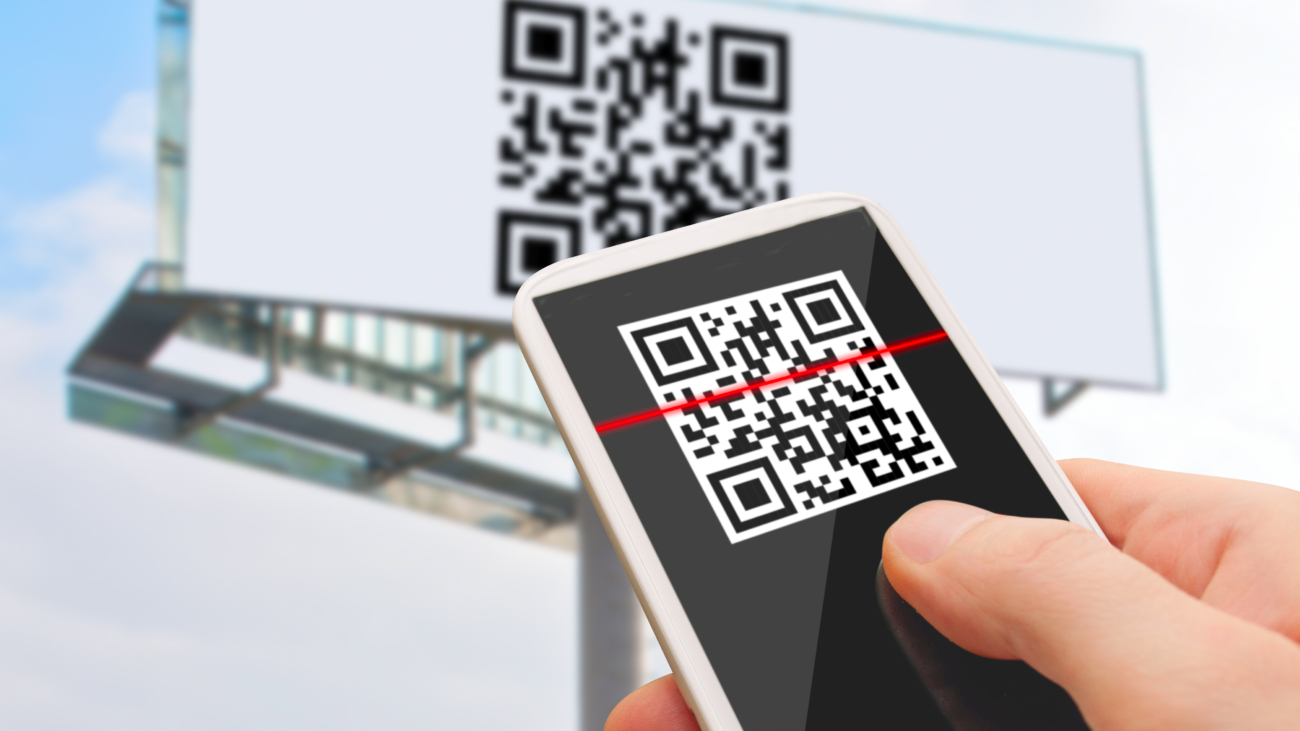 Image of a user scanning a QR code on a billboard