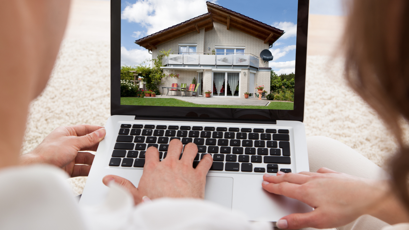 An image of a couple viewing a house on a laptop