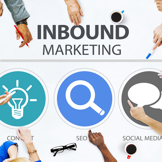 Image of people sitting around a table with inbound marketing words in the middle